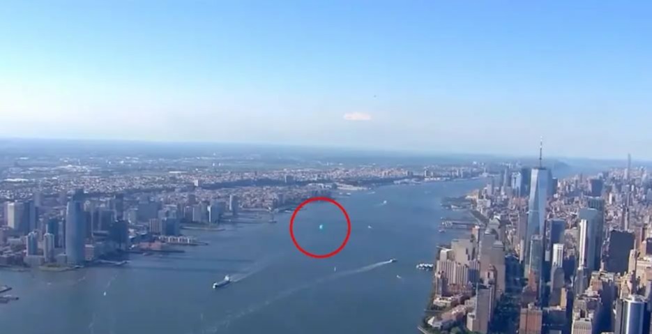 an aerial view of new york city with a red circle in the middle