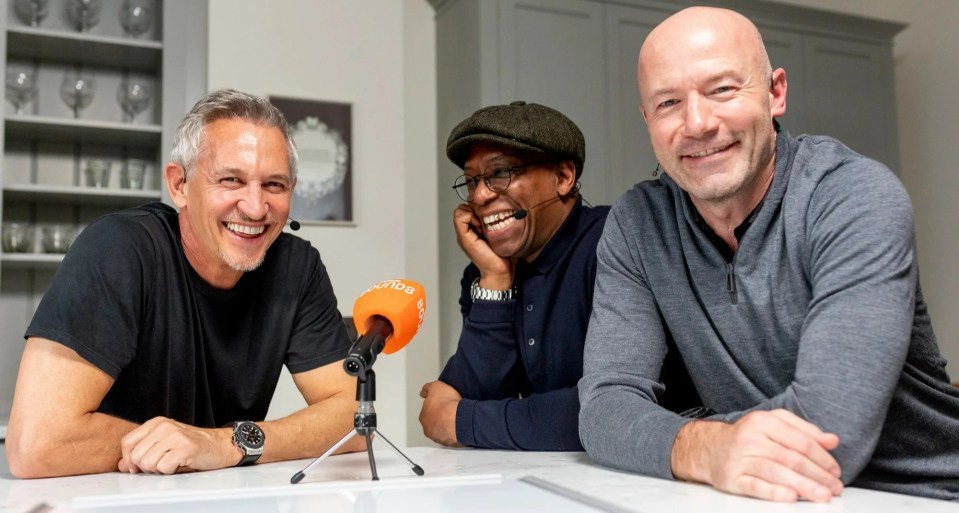 three men are sitting in front of a microphone that says bbc on it