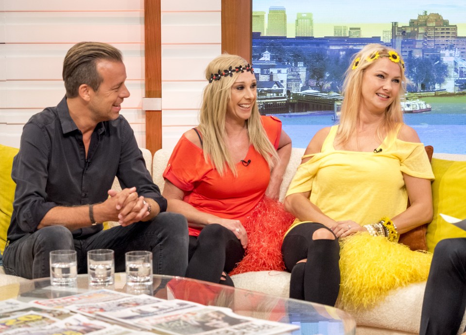 a man and two women are sitting on a couch