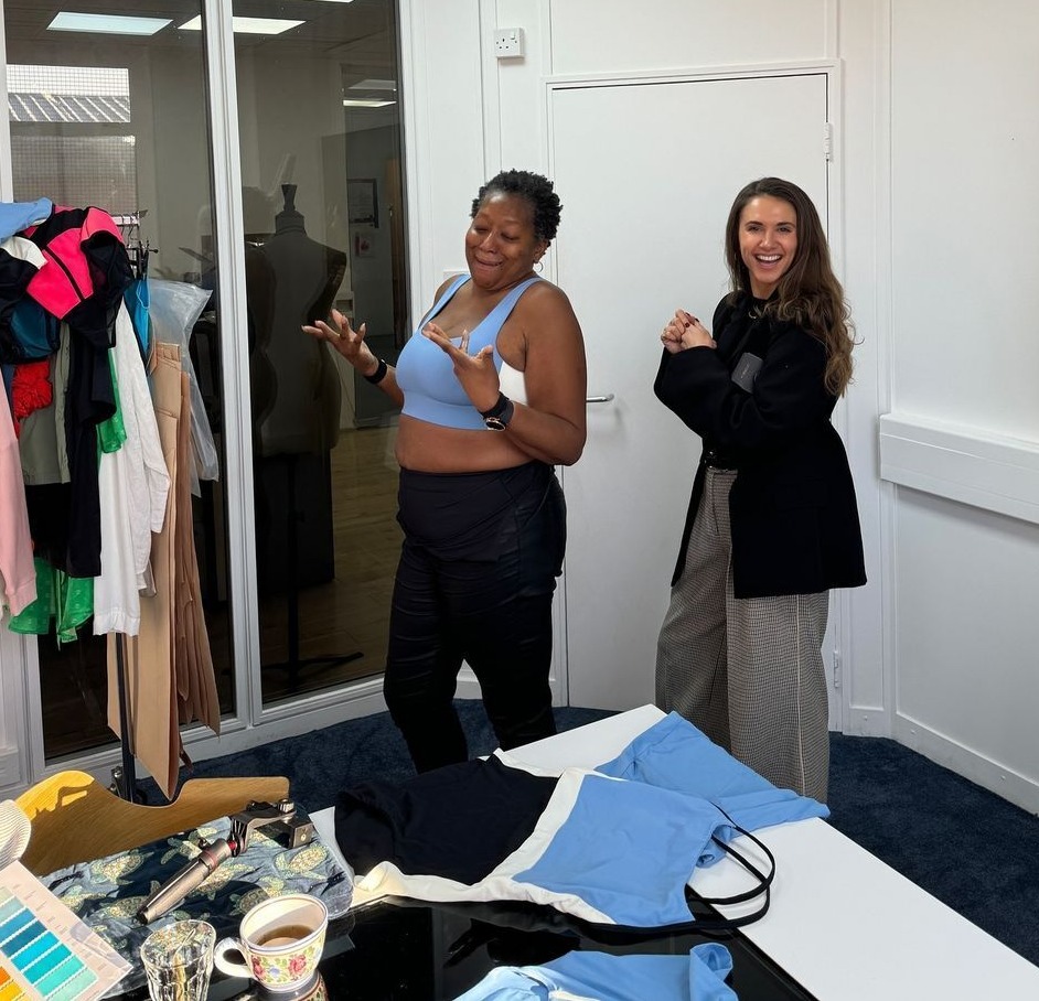 two women standing next to each other in a room