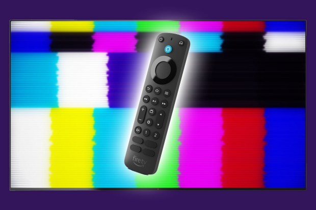 a fire tv remote is sitting in front of a colorful screen