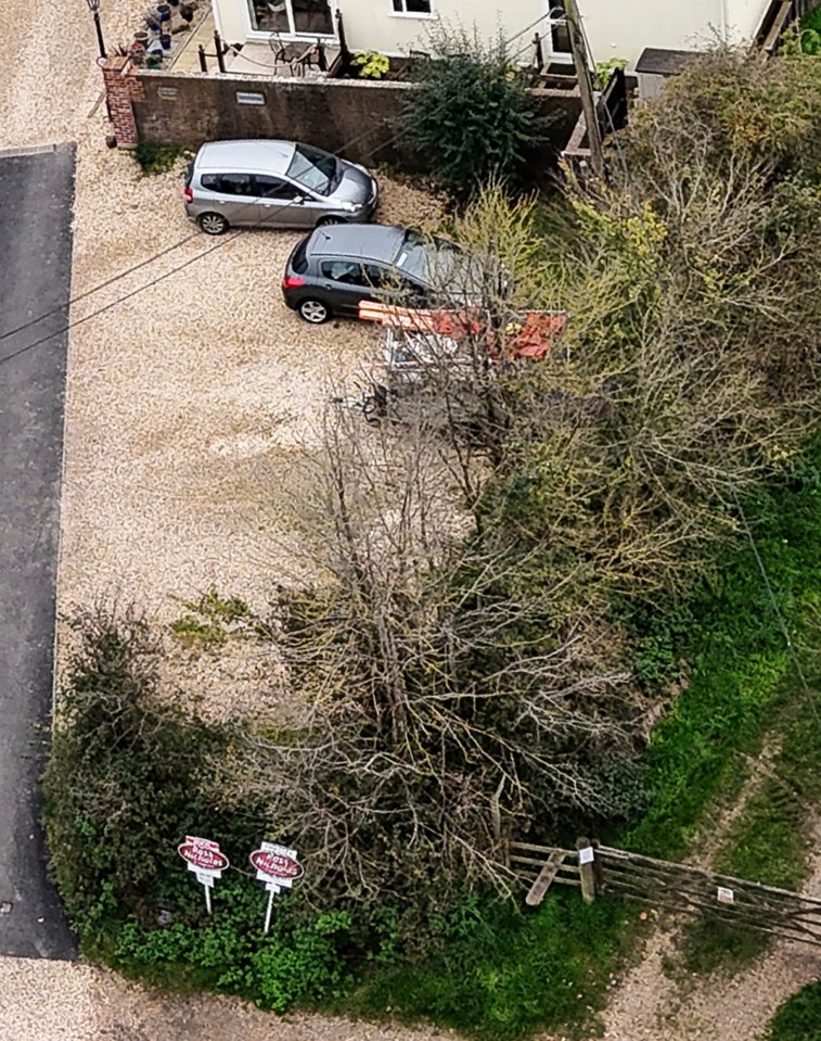 an aerial view of a car parked in front of a house