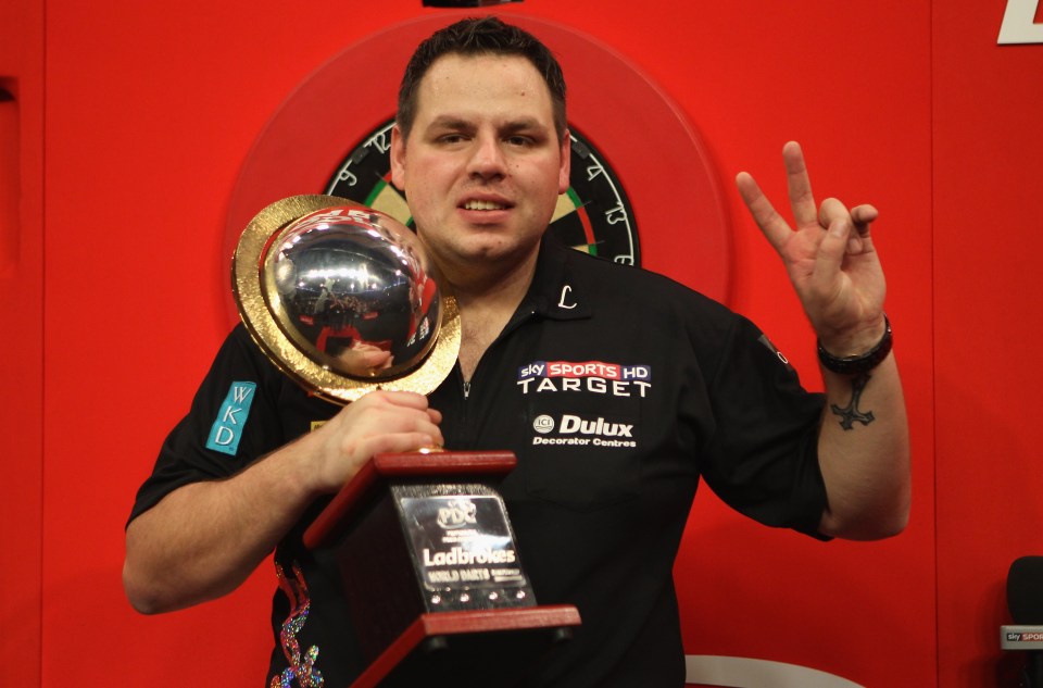 Adrian Lewis holding the World Darts Championship trophy.