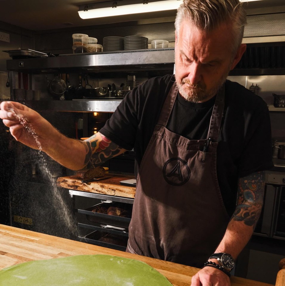 a man wearing an apron with the letter a on it