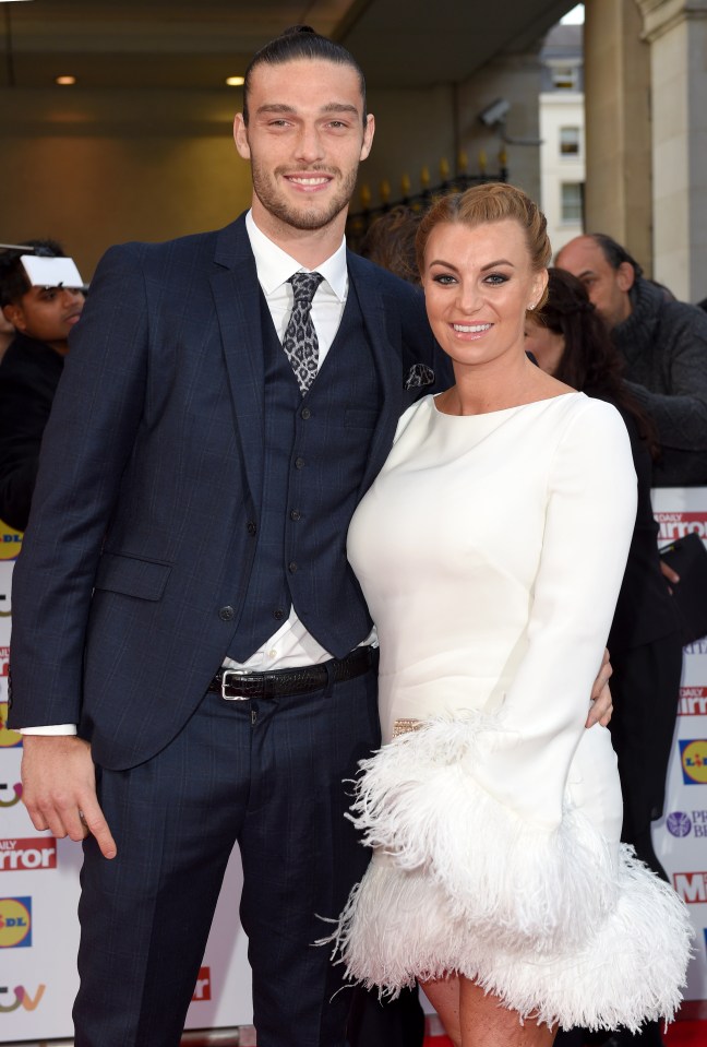 a man in a suit and tie stands next to a woman in a white dress