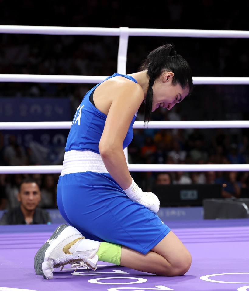 a woman in a boxing ring with the letter a on her shirt