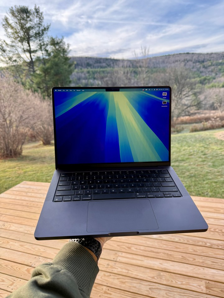 a person is holding a laptop with a blue screen