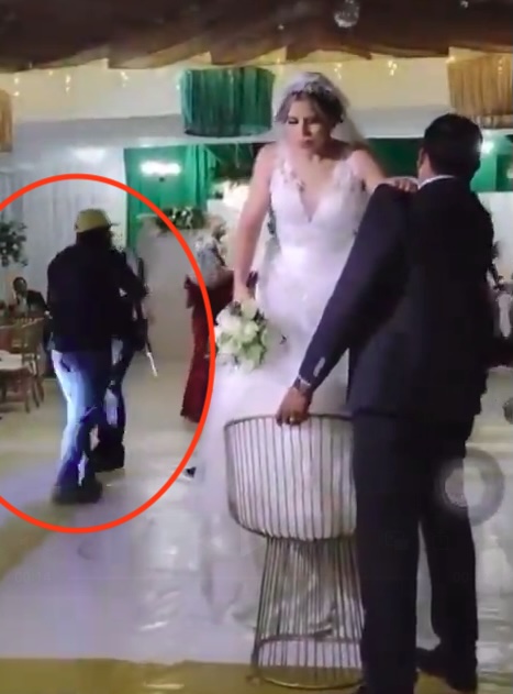 The bride was about to toss her bouquet when the gunman stormed in