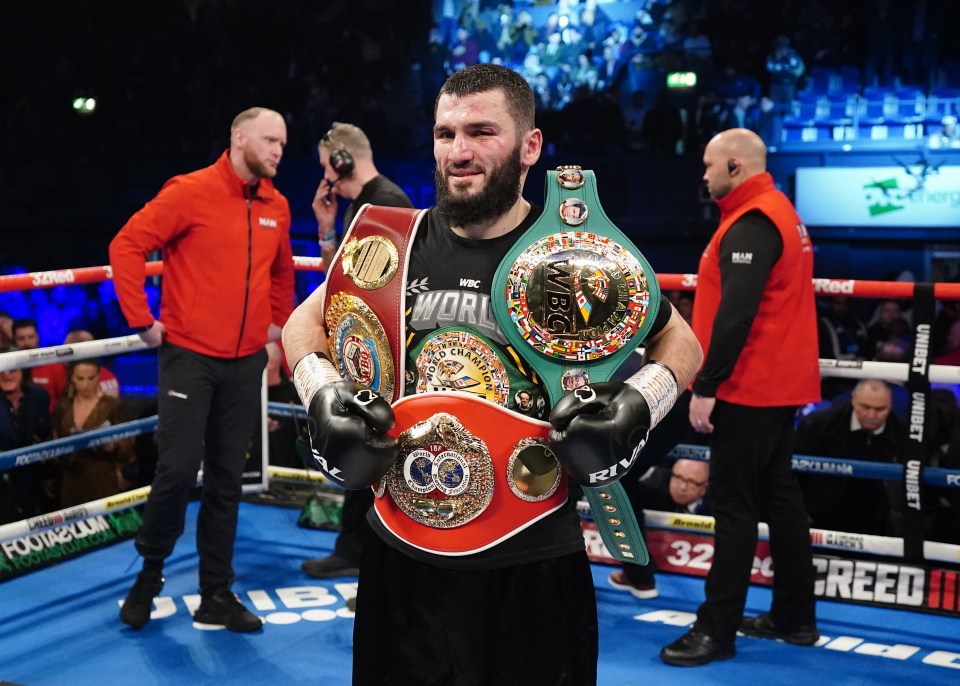 a man in a boxing ring with a belt that says ' world ' on it