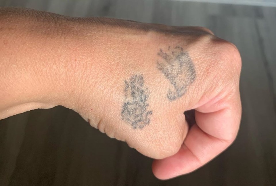 a close up of a person 's hand with a tattoo on it