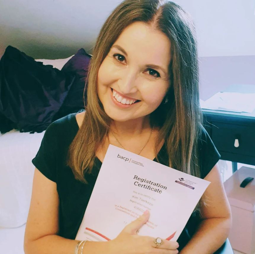 a woman holds up a certificate that says registration certificate