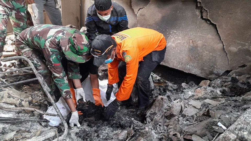 Indonesia’s Search and Rescue Agency (BASARNAS) rescuers search for victims of the Lewotobi Laki-Laki volcano eruption on Flores Island