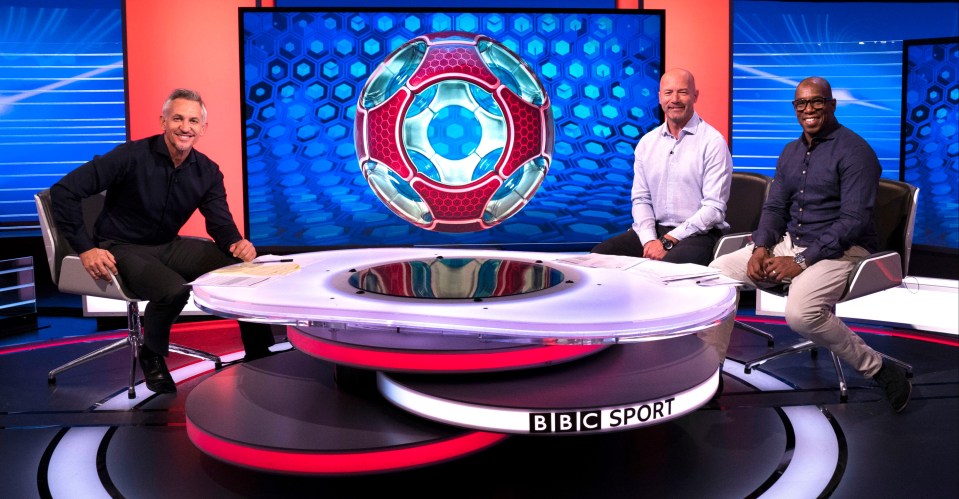 three men sit in front of a bbc sport sign