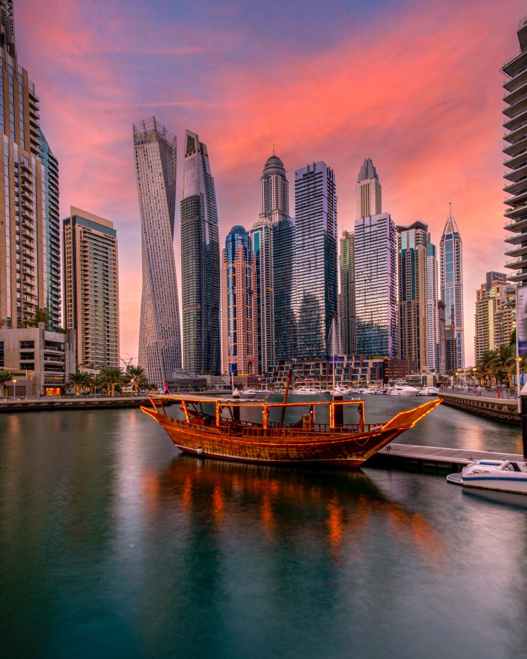 a boat is docked in front of a city skyline