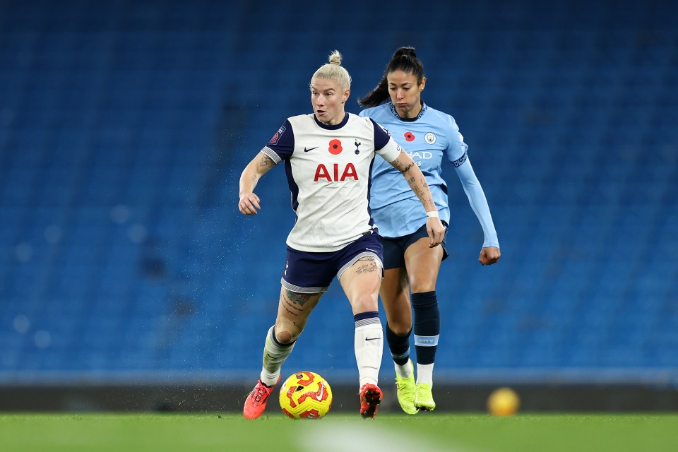 two female soccer players with one wearing an aia jersey