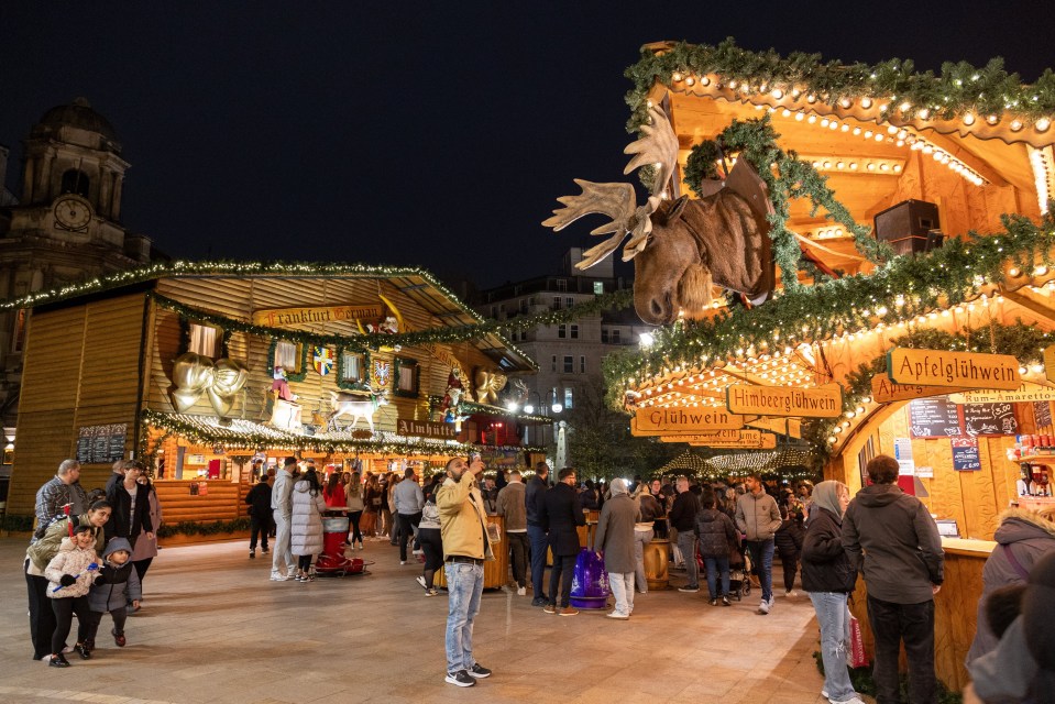 a crowd of people are gathered at a christmas market