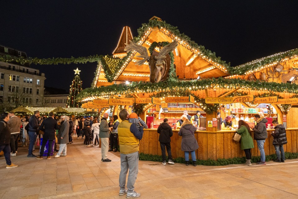 a christmas market with a sign that says glückwein