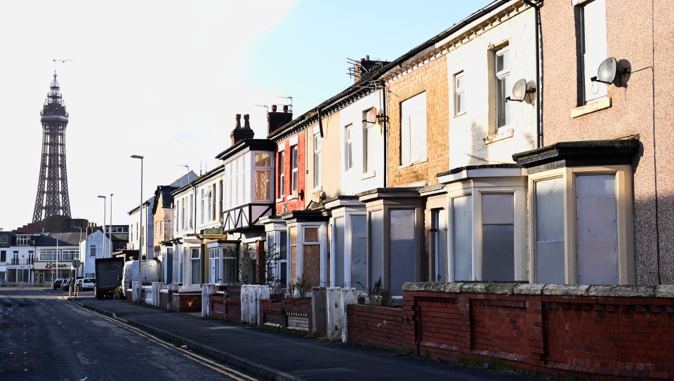 Houses on a residential street are boarded up