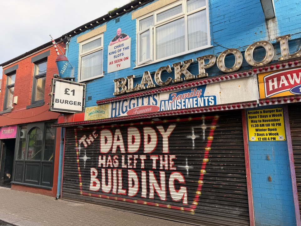 The burger store shutter is covered in graffiti