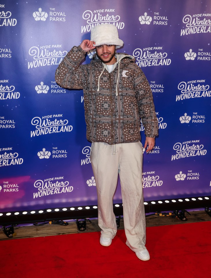 a man stands on a red carpet at the hyde park winter wonderland