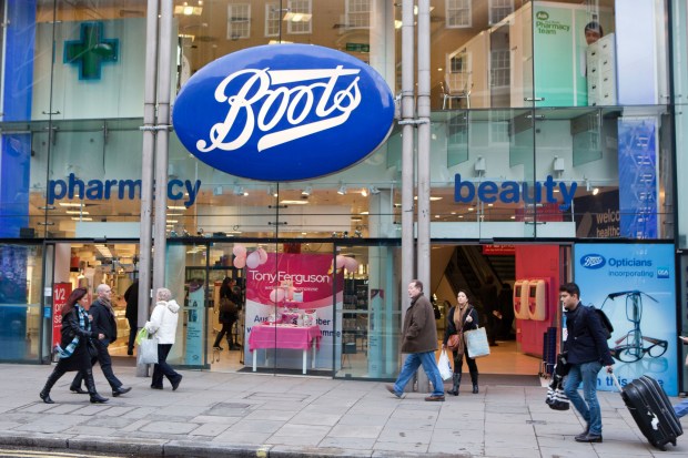 people walking in front of a boots beauty store