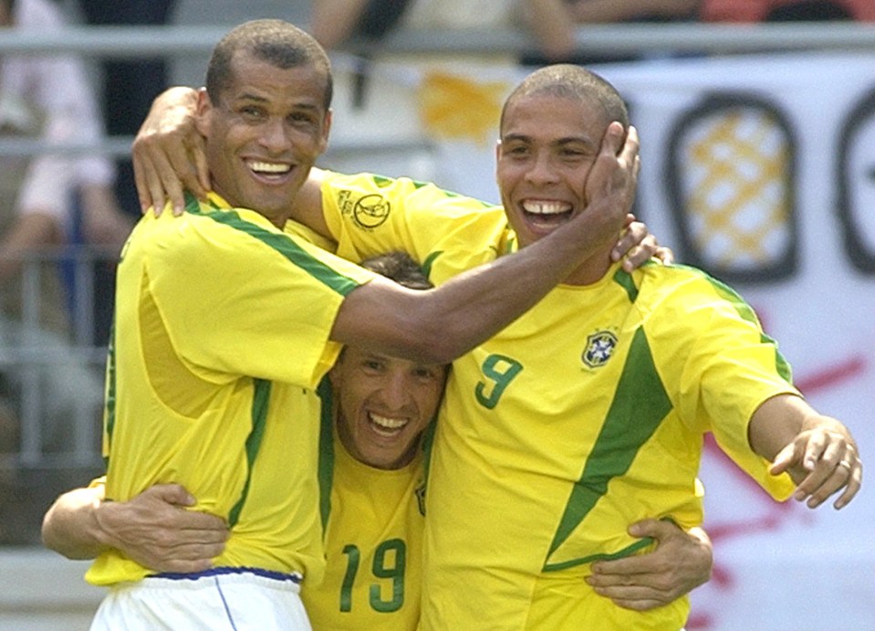 three soccer players are hugging and one has the number 19 on his shirt