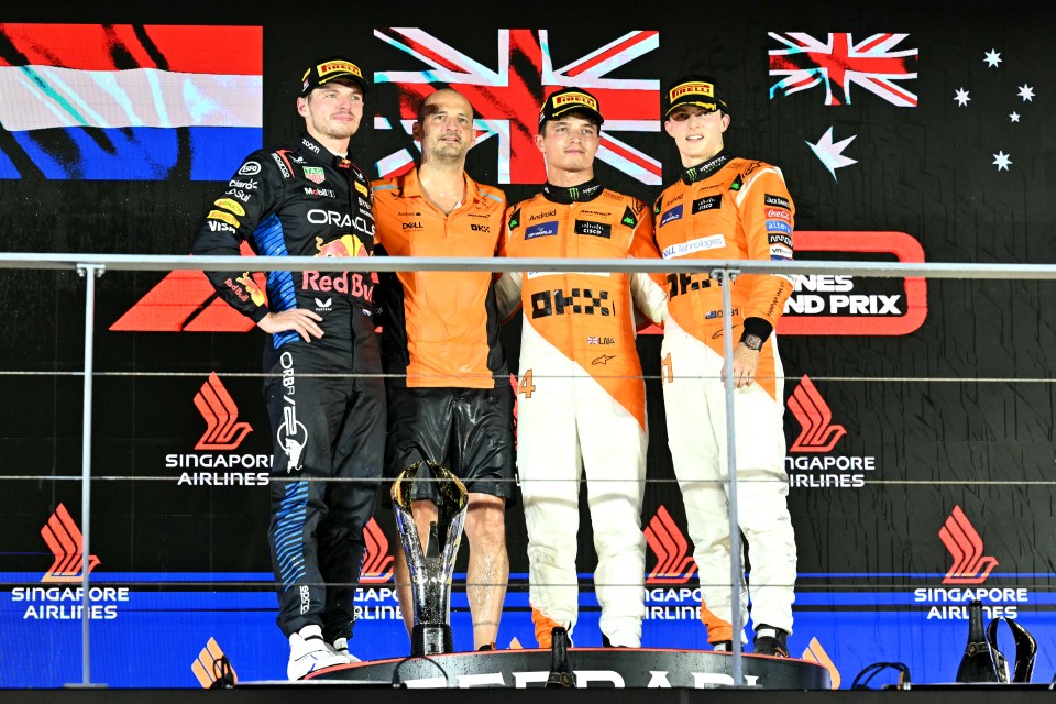 a group of men standing on a podium that says singapore airlines