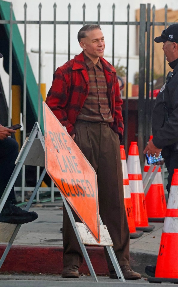 a man standing next to a sign that says bike lane closed