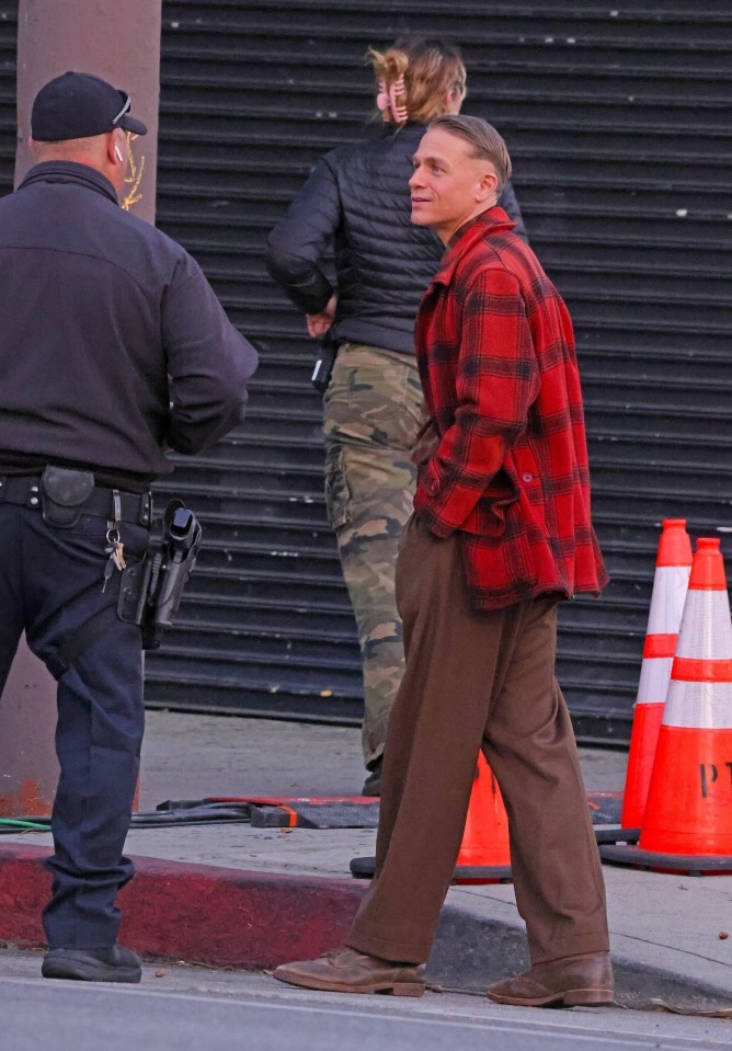 a man in a plaid shirt is standing next to a police officer