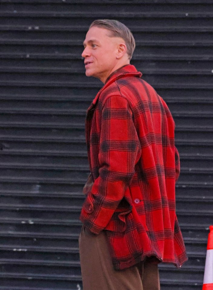 a man wearing a red and black plaid jacket