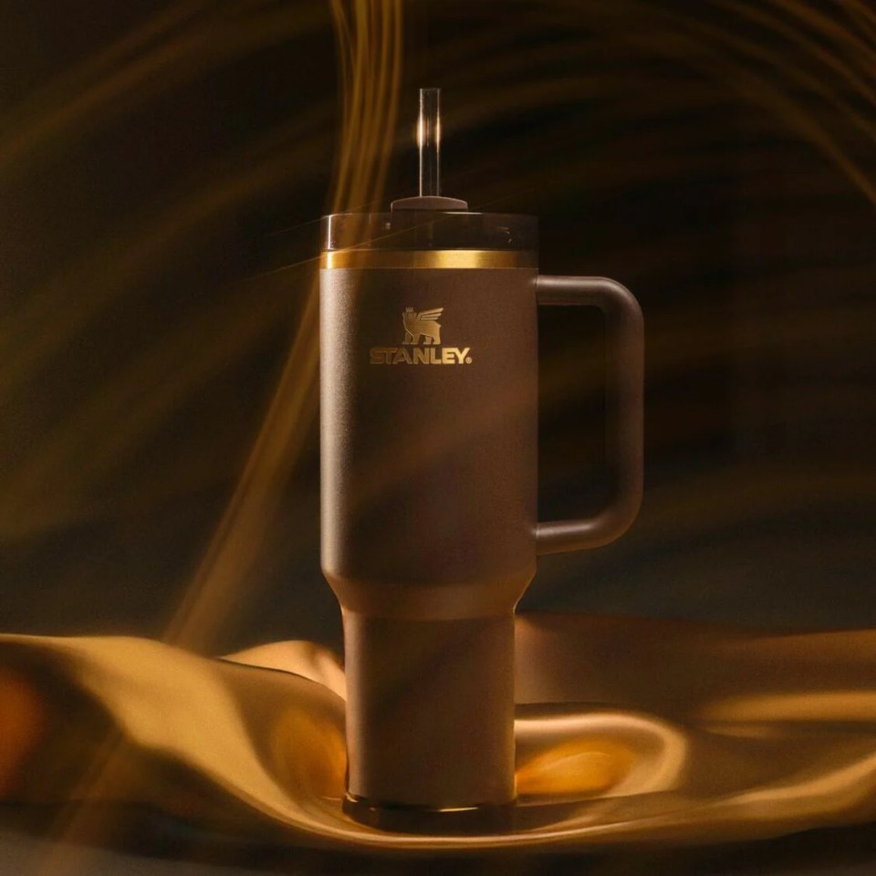 a brown stanley coffee mug with a straw