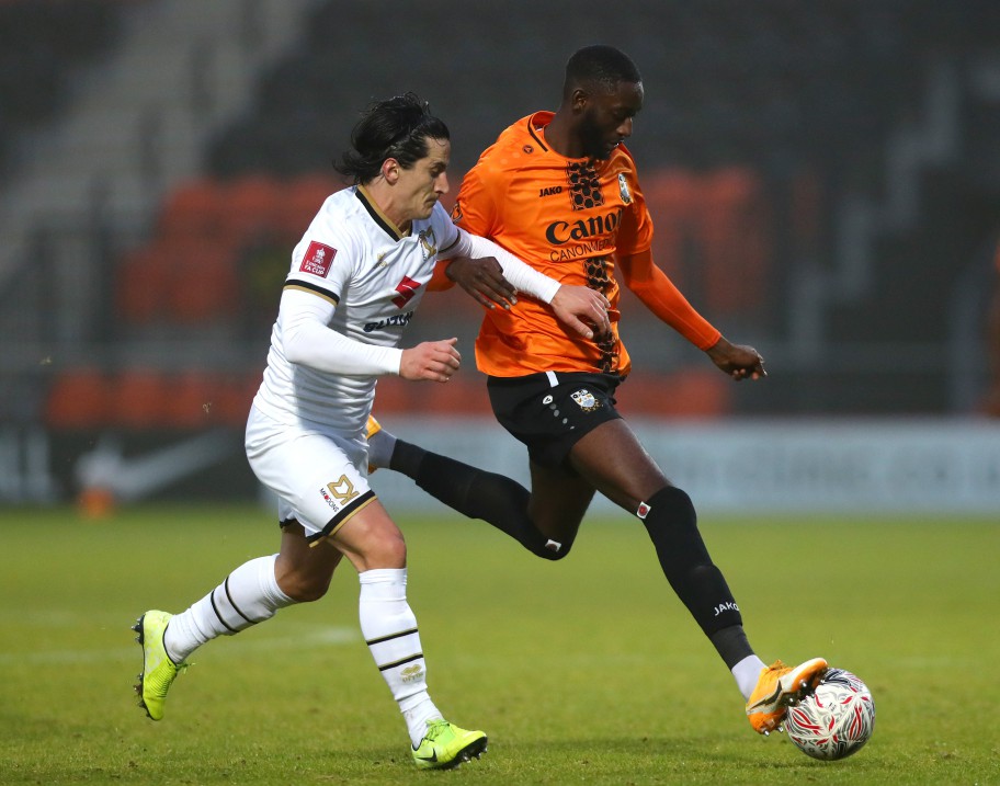 BARNET, ENGLAND - NOVEMBER 29: George Williams of MK Dons and Muhammadu Faal of Barnet battle for the ball during the FA Cup Second Round match between Barnet and Milton Keynes Dons on November 29, 2020 in Barnet, England. Sporting stadiums around the UK remain under strict restrictions due to the Coronavirus Pandemic as Government social distancing laws prohibit fans inside venues resulting in games being played behind closed doors. (Photo by Chloe Knott - Danehouse/Getty Images)