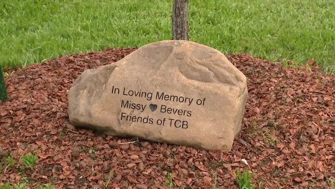 a large rock with the words `` in loving memory of missy bevers friends of tcb '' written on it .