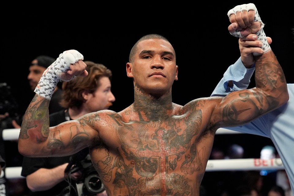 a man in a boxing ring with a bet logo in the background