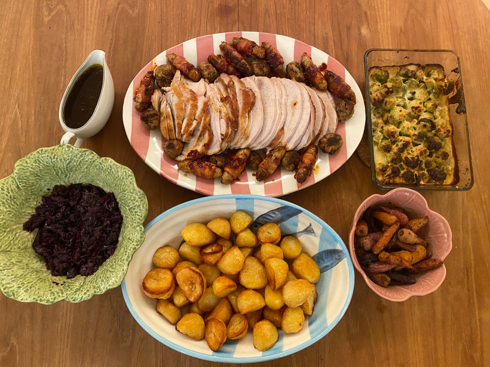 a table topped with plates of food including potatoes