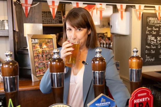 a woman drinking from a tap that says horizon