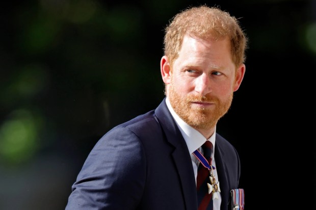 a man with a medal around his neck is wearing a suit and tie