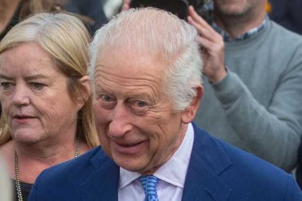 a man in a blue suit and tie is smiling