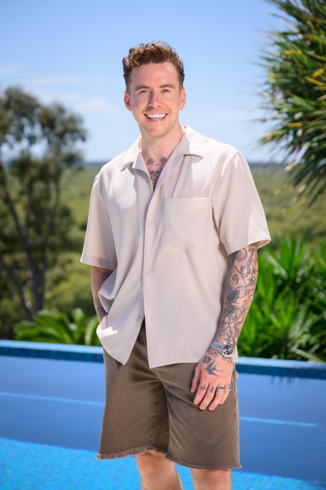 a man with a tattoo on his arm is standing next to a pool