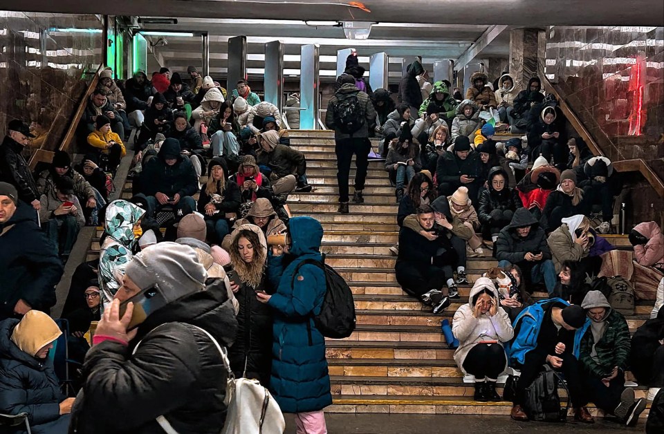 a group of people sitting on stairs with a van dobroncov telegram logo on the ground