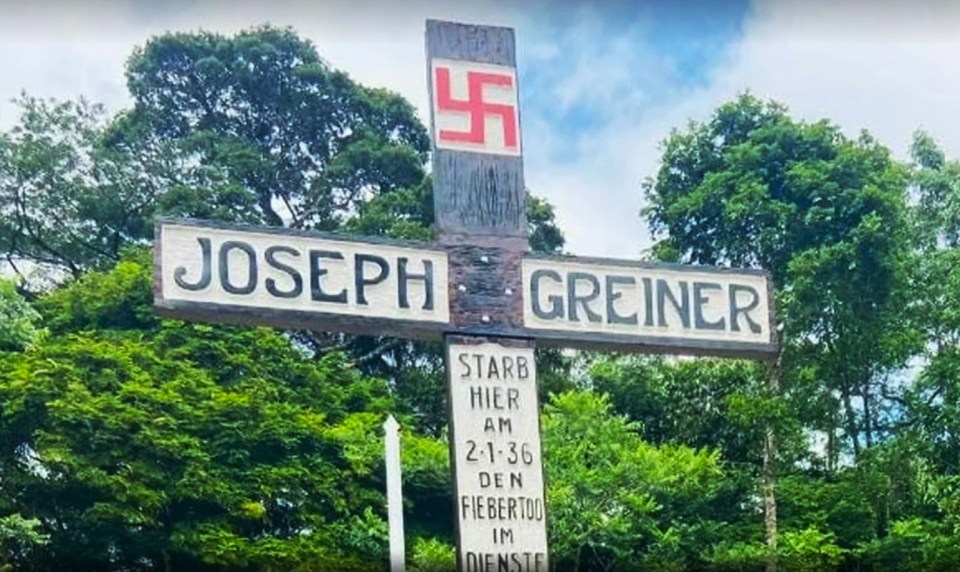 The nine-foot high wooden cross features a Nazi swastika