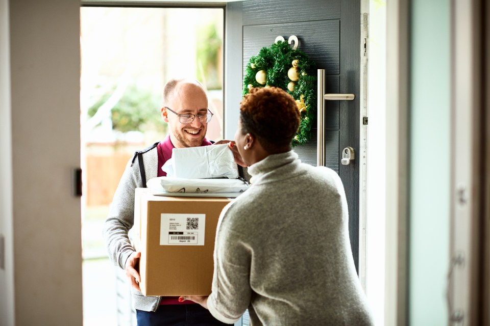 a man is delivering a box to a woman with a qr code on it