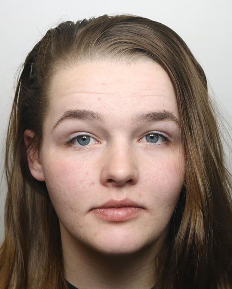 a close up of a woman 's face with blue eyes