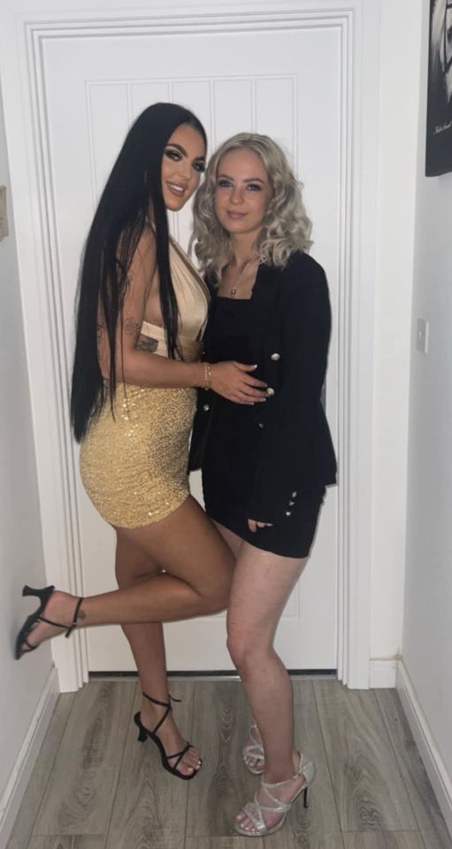 a woman in a gold dress is standing next to another woman in a black dress