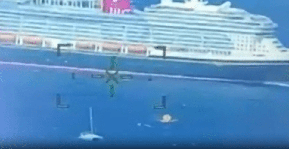 a small plane is flying in front of a large cruise ship