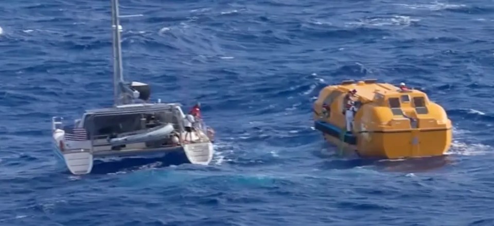 a boat in the ocean with a yellow buoy attached to it