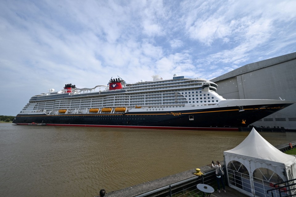 a large cruise ship with the word disney on the side