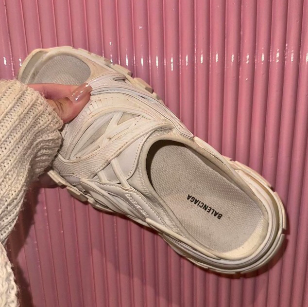 The soles of the shoes appear to be worn and the white colour is faded and slightly grubby