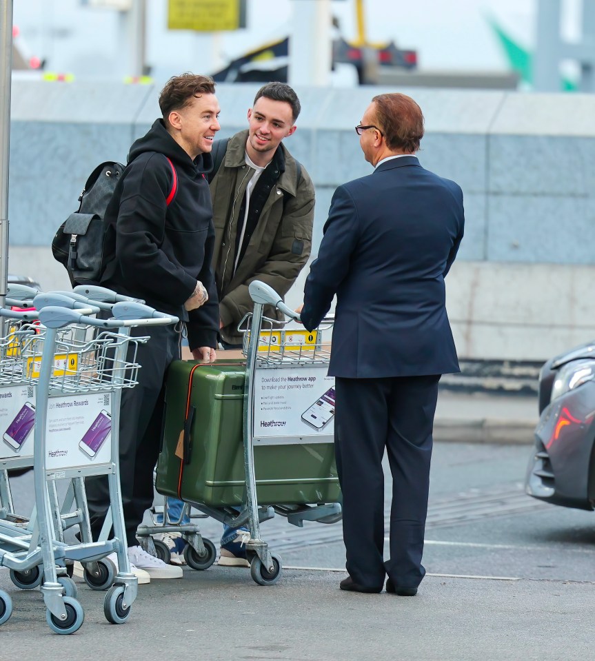 He looked in a good mood as he chatted to airport staff