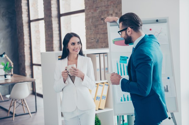 a man and a woman are standing in front of a white board with a graph on it that says financial planning